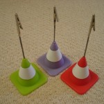 Quirky traffic cone place card holders which double up as photo display favours